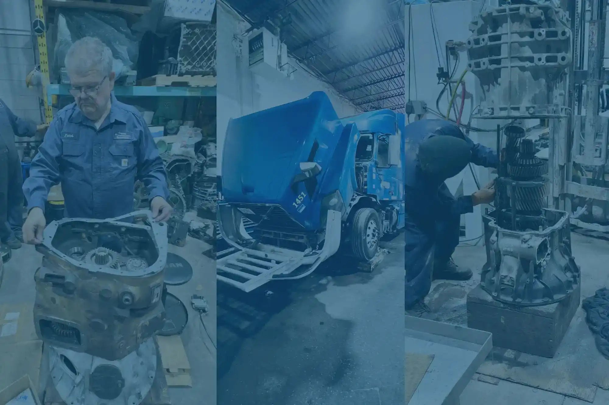 Multiple workers performing repairs on heavy vehicle parts and a blue truck.